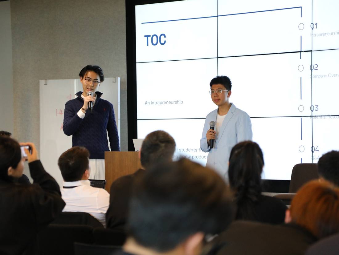 Two presenters addressing an audience during an entrepreneurship session