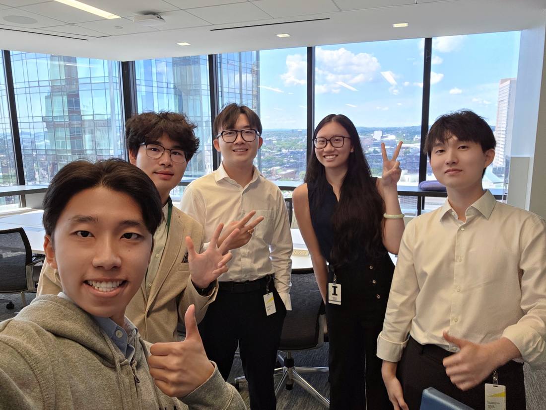 Five young participants smiling together after a program activity