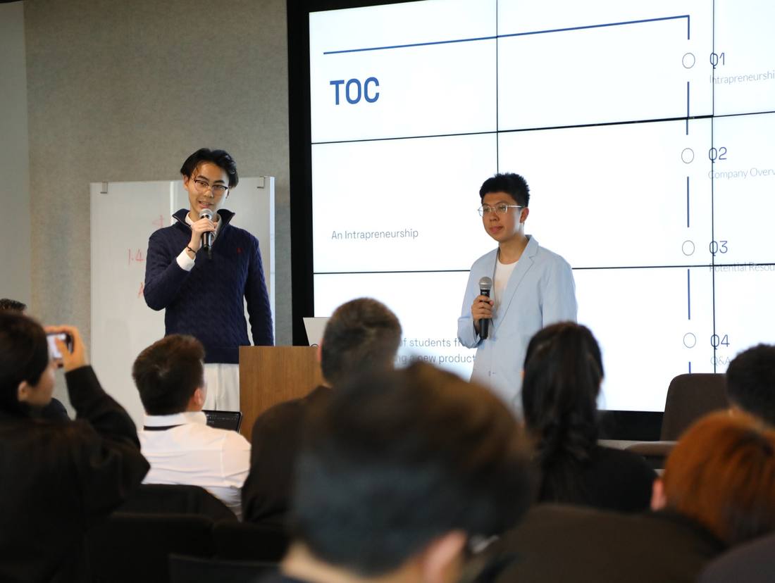 Two young presenters sharing their project with an audience