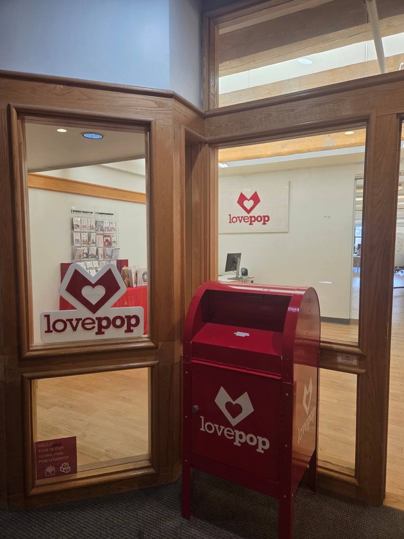 Lovepop entrance with branded signs and a red mailbox