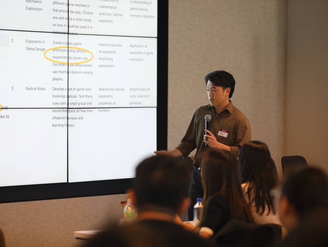 A young presenter explaining a project to an audience during a pitch competition