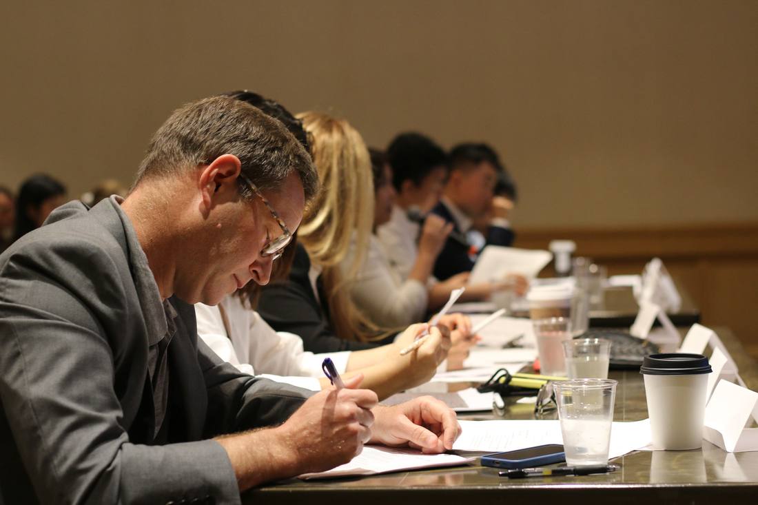 Judges and mentors reviewing written materials together during a SparkHub event