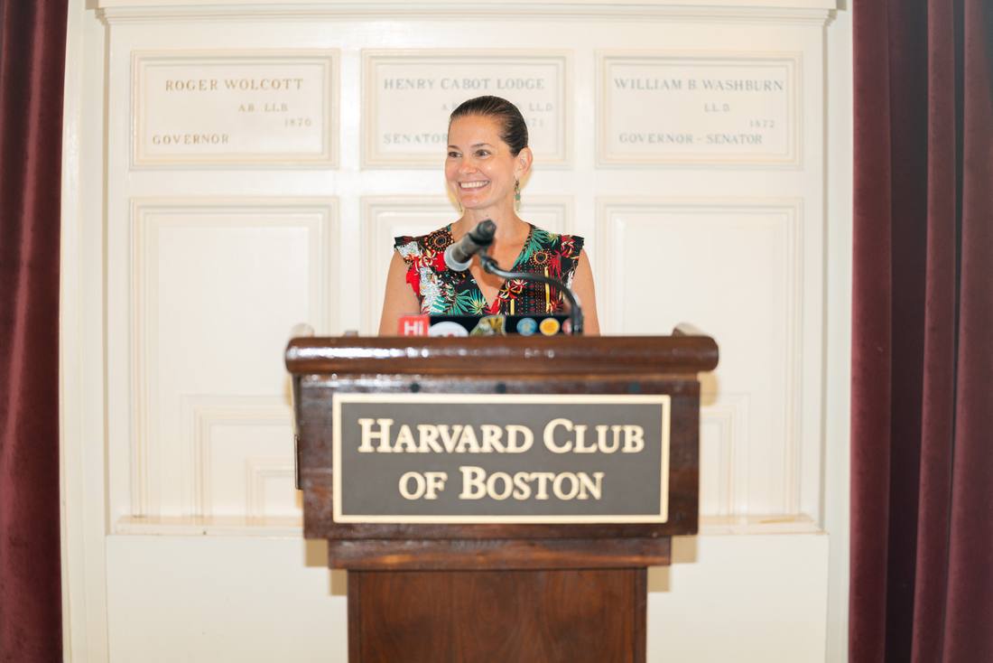 A speaker addressing an audience at the Harvard Club of Boston