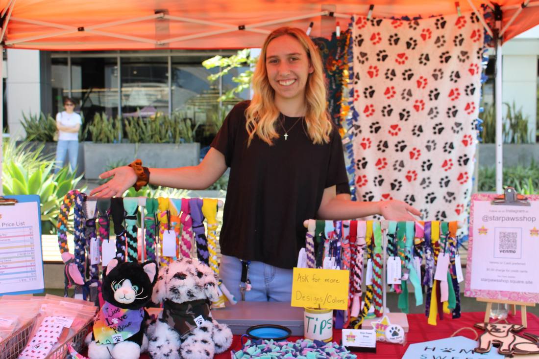 A young entrepreneur presenting products at a 2025 fair booth