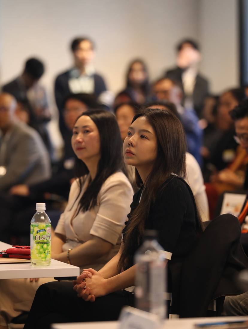 Two audience members listening during the competition program