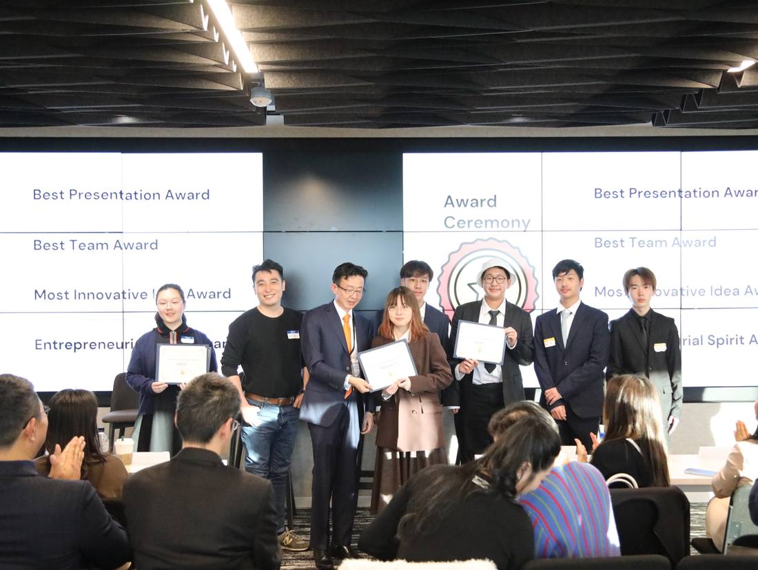 Certificate recipients standing on stage during the award ceremony